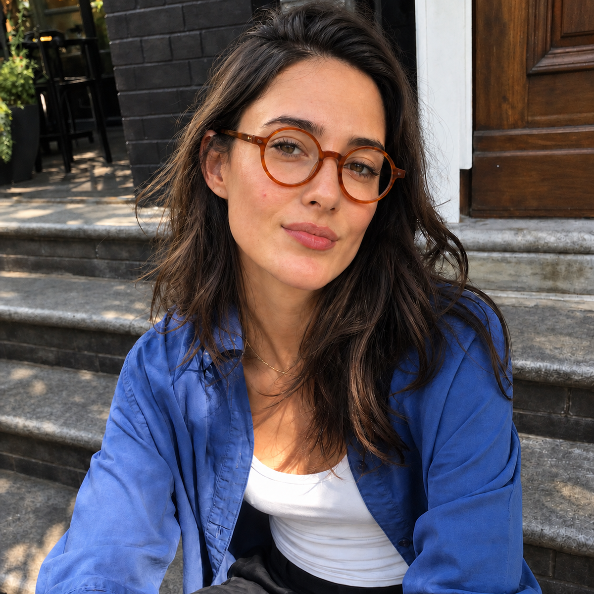 Woman wearing Marlow amber brown round optical glasses seated on steps